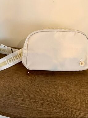 lululemon athletica Cream Crossbody Bag with Gold Logo Strap